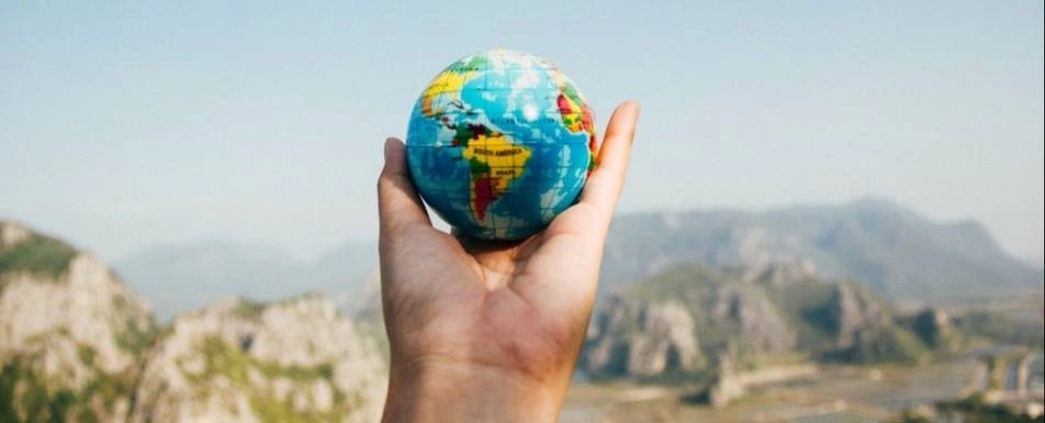 A man holding a globe.