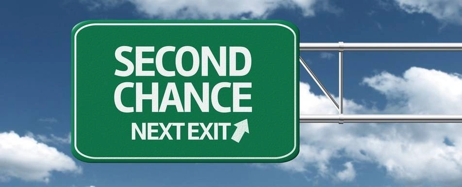 A road exit sign that says 'Second Chance'.