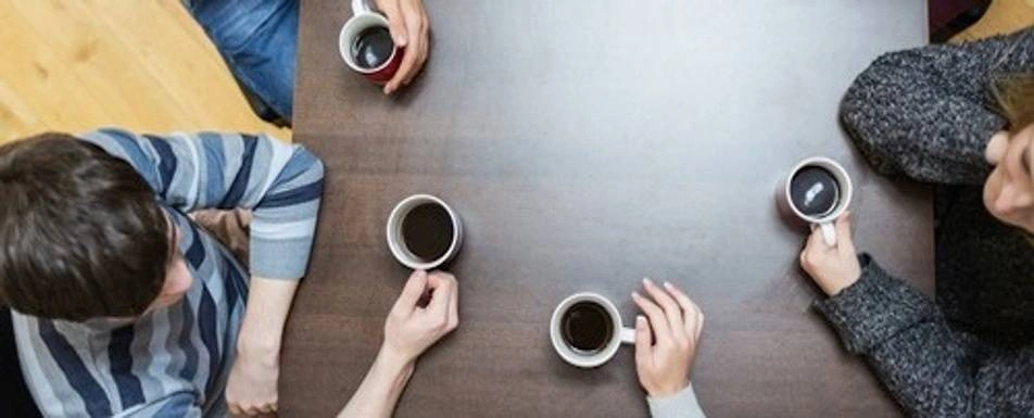 A group of people having coffee together.