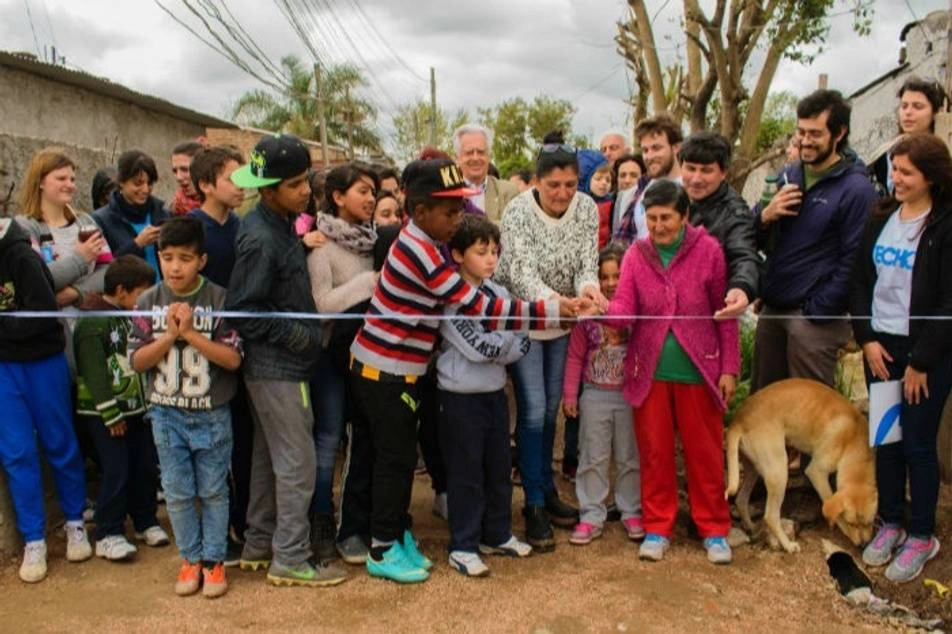 A group of people cutting a ribbon.