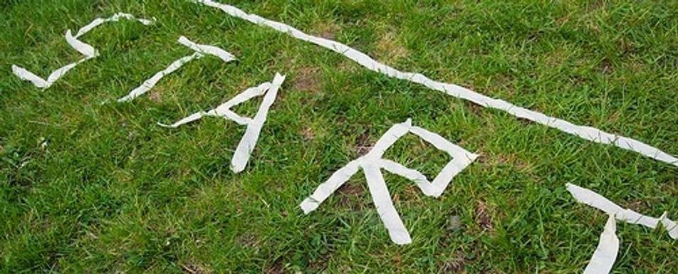The word start spelled out in tape on the grass.