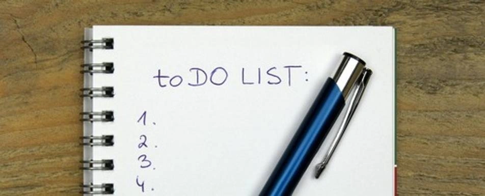 A numbered to-do list on a notepad.