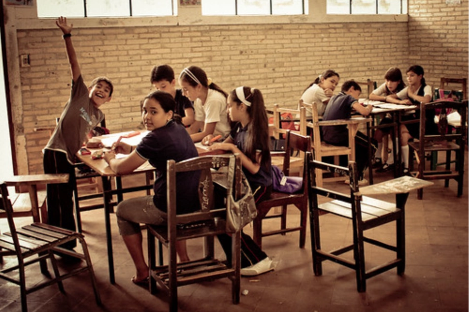 Niños trabajando en grupos en un aula de clases