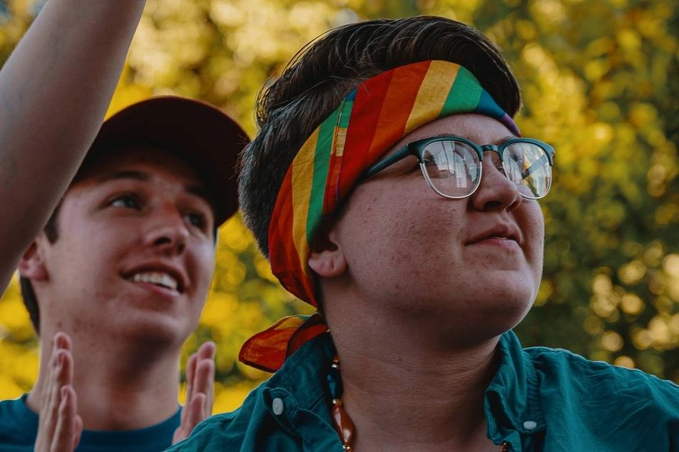 person with rainbow bandana smiling