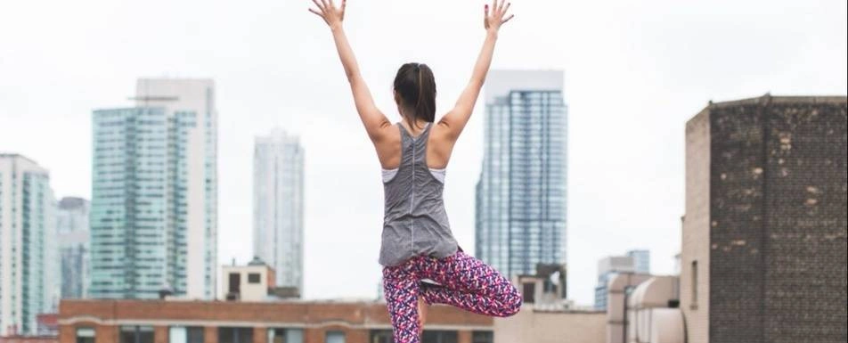 A person on a rooftop doing yoga.