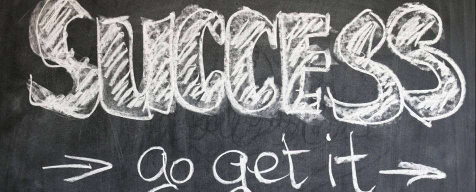 "Success, go get it", written on a chalk board.
