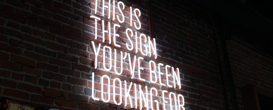 A neon sign that says 'This is the sign you've been looking for'.