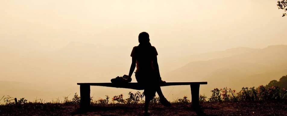 A woman watching a sunset.