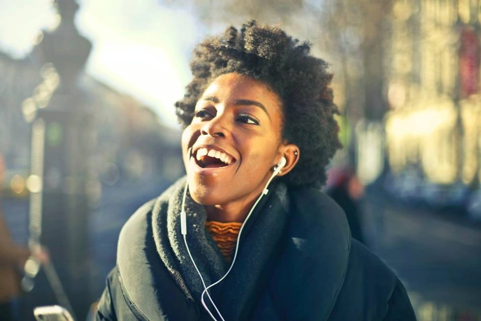 woman smiling listening through earphones